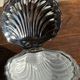 Vintage silver-plated shell butter dish with transparent bowl.