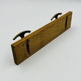 Vintage wall coat rack in brass and wood design.