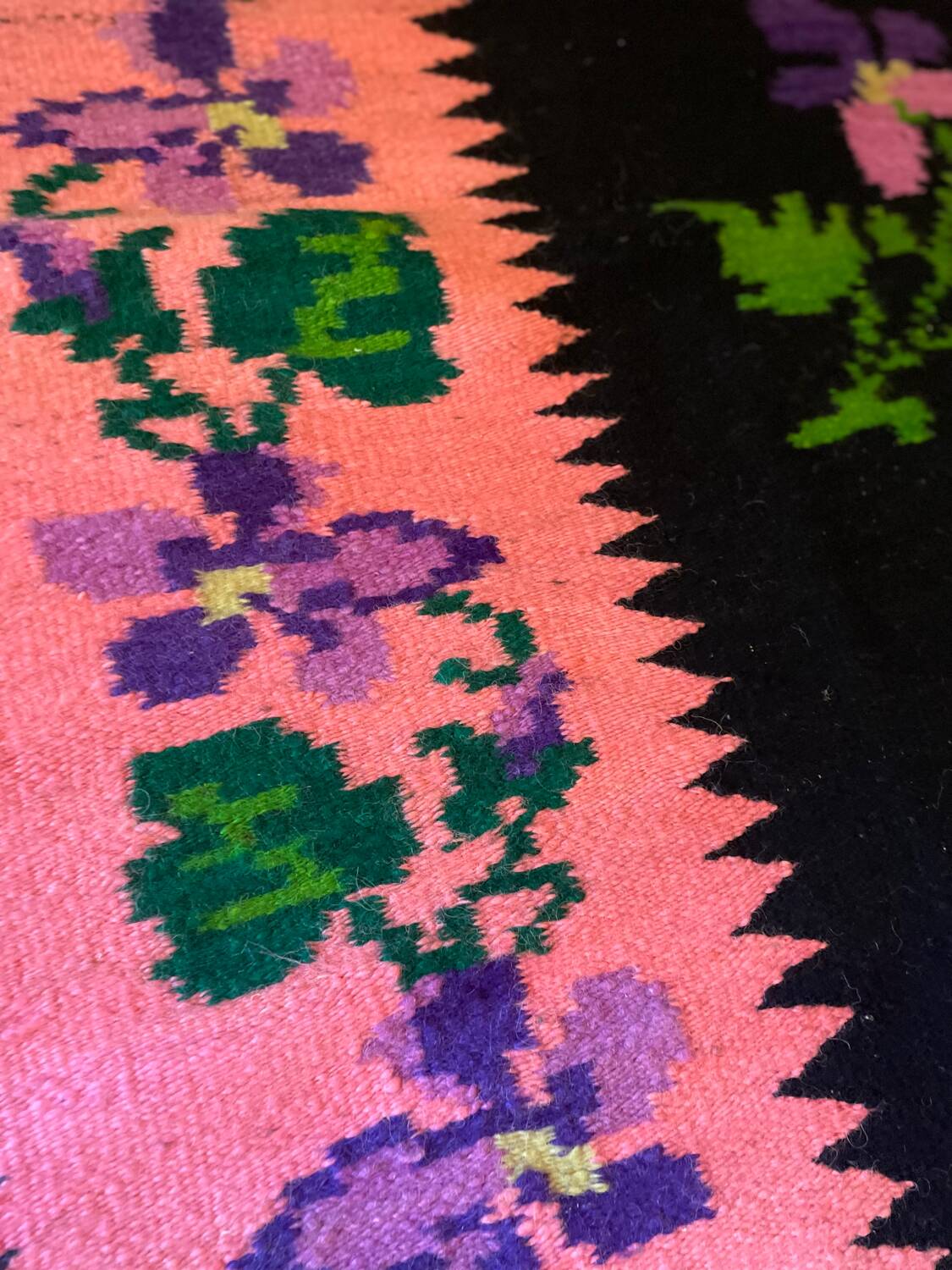 Oltenian floral rug handwoven in wool, purple flowers on black and pink background