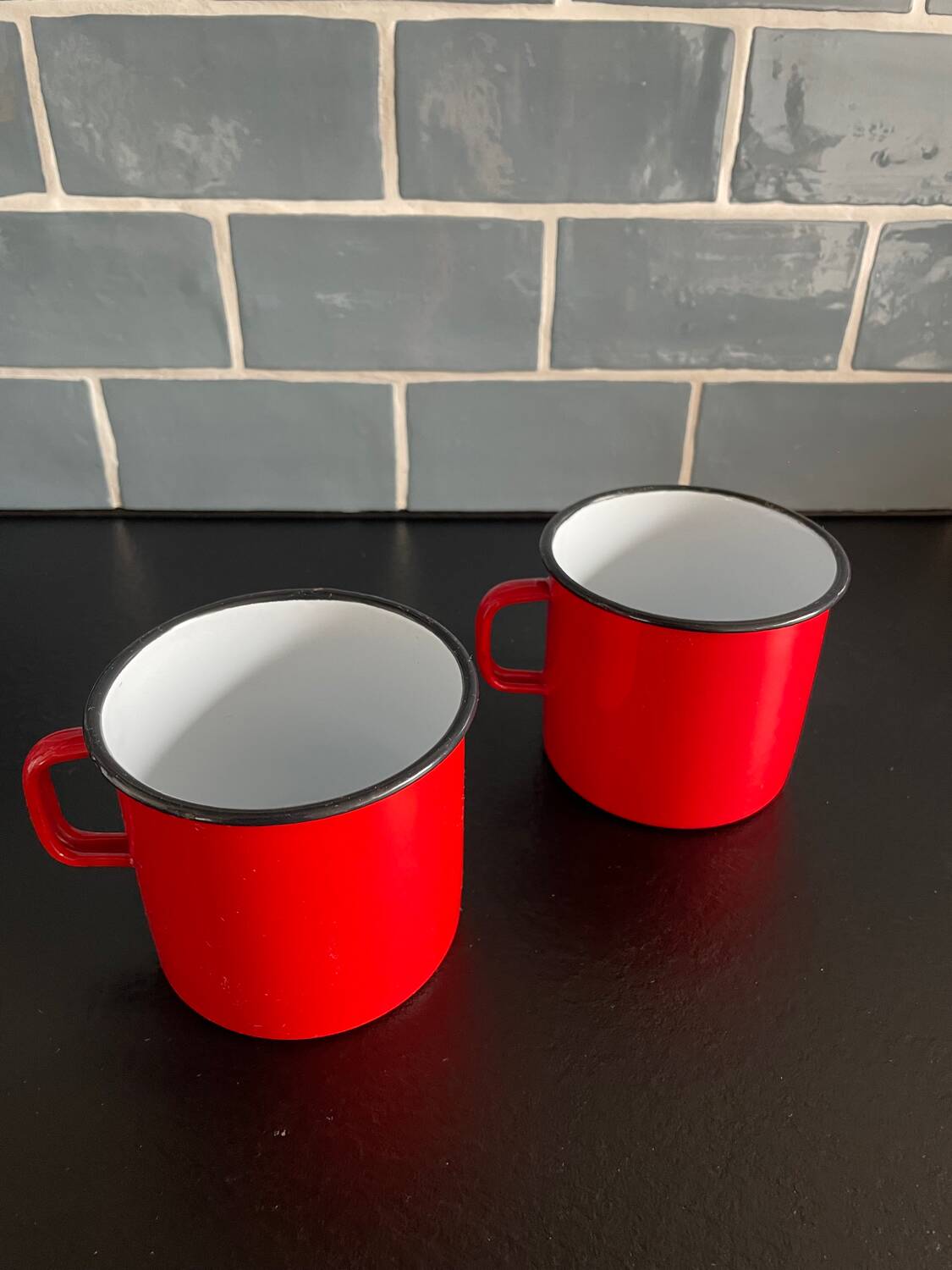 Red enameled sheet metal mug