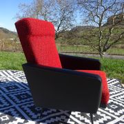 Pair of vintage armchairs in black faux leather and red fabric.