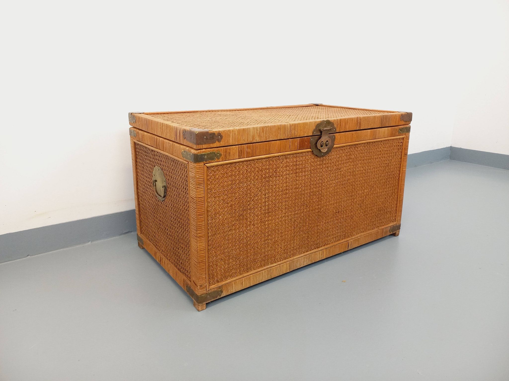 Vintage trunk in wood, rattan, caning, and brass.