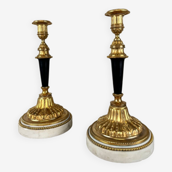 Pair of gilded and patinated bronze candlesticks