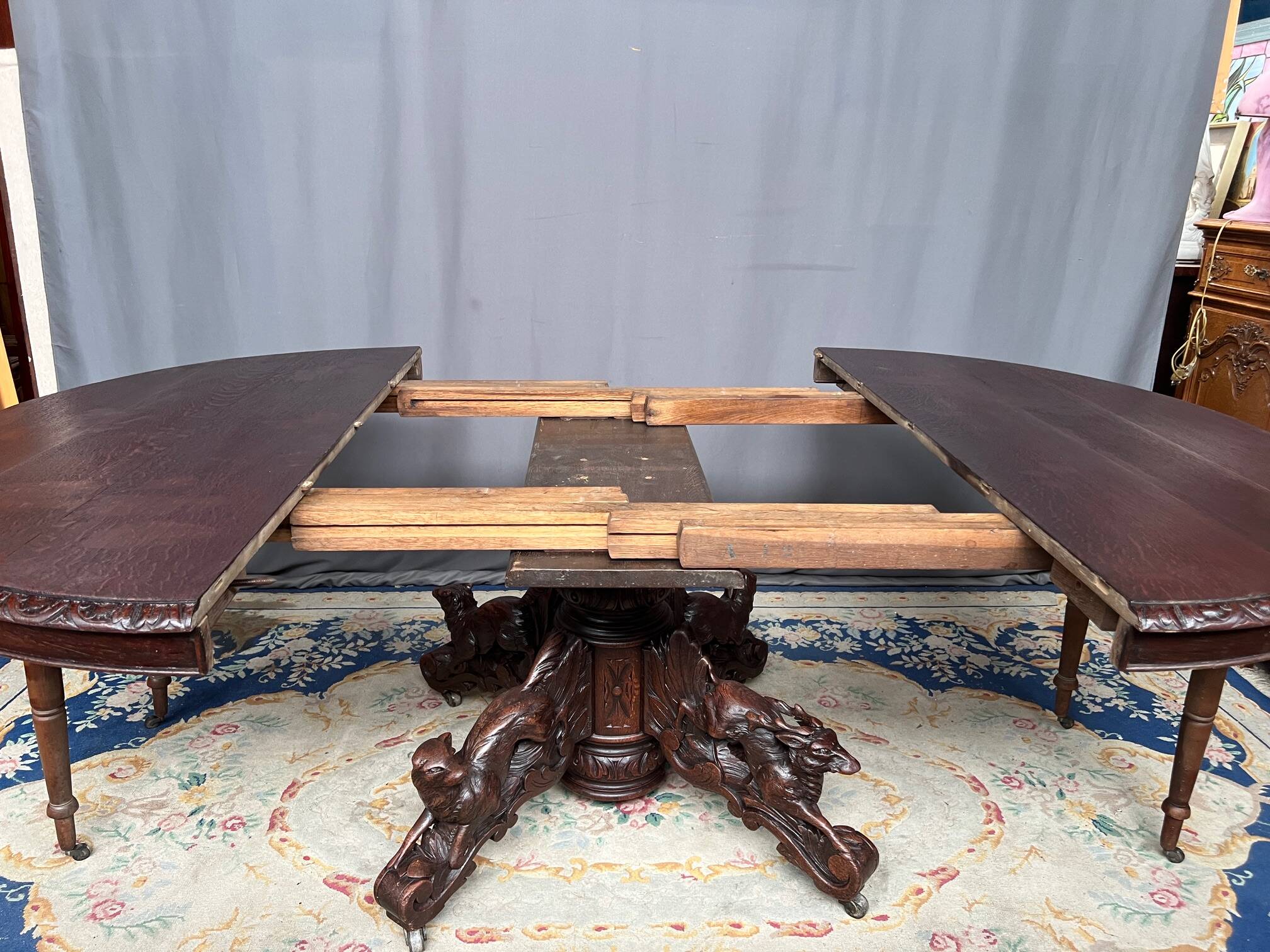 Hunting style dining table with figures of four different animals.