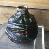 Small Dalpayrat vase shaped ball in polychrome glacured ceramic with relief decoration of a flower signed under the base
