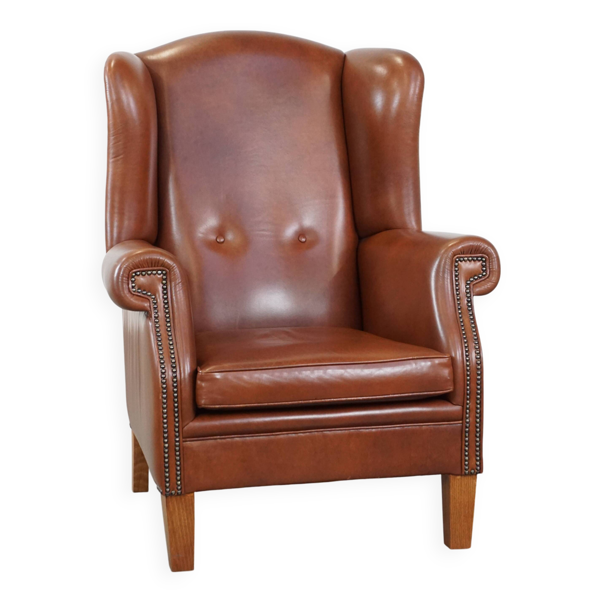 Cognac-colored leather wingback chair in English style