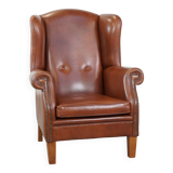 Cognac-colored leather wingback chair in English style