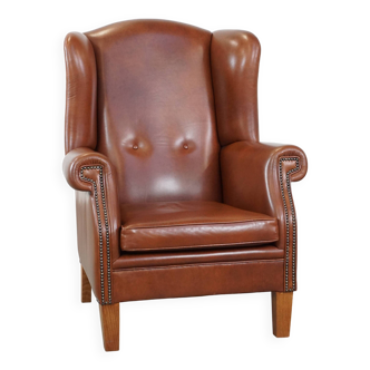Fauteuil à oreilles en cuir couleur cognac de style anglais