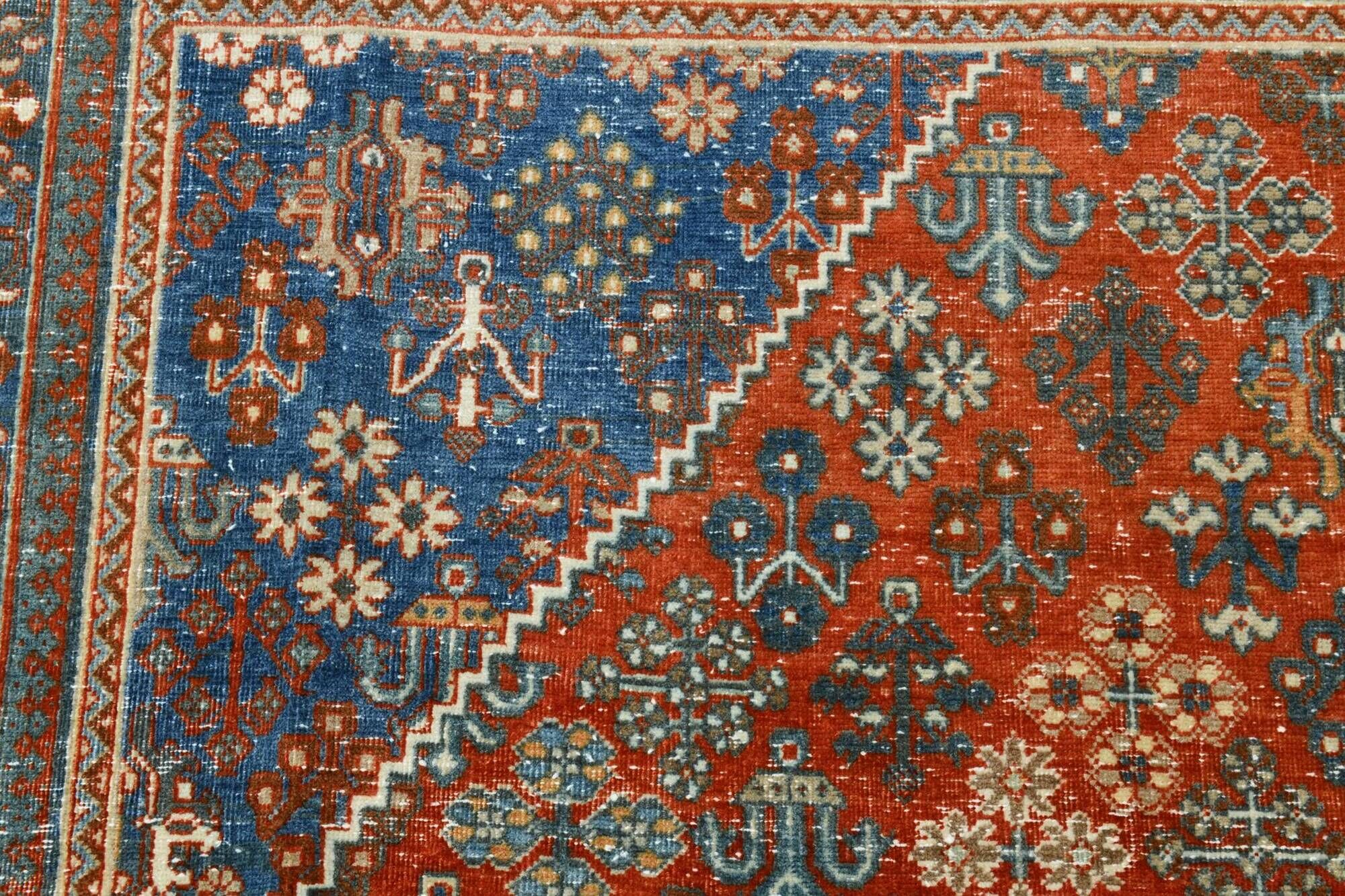 Vintage Turkish rug in brick red and indigo with floral design, 276 × 389 cm