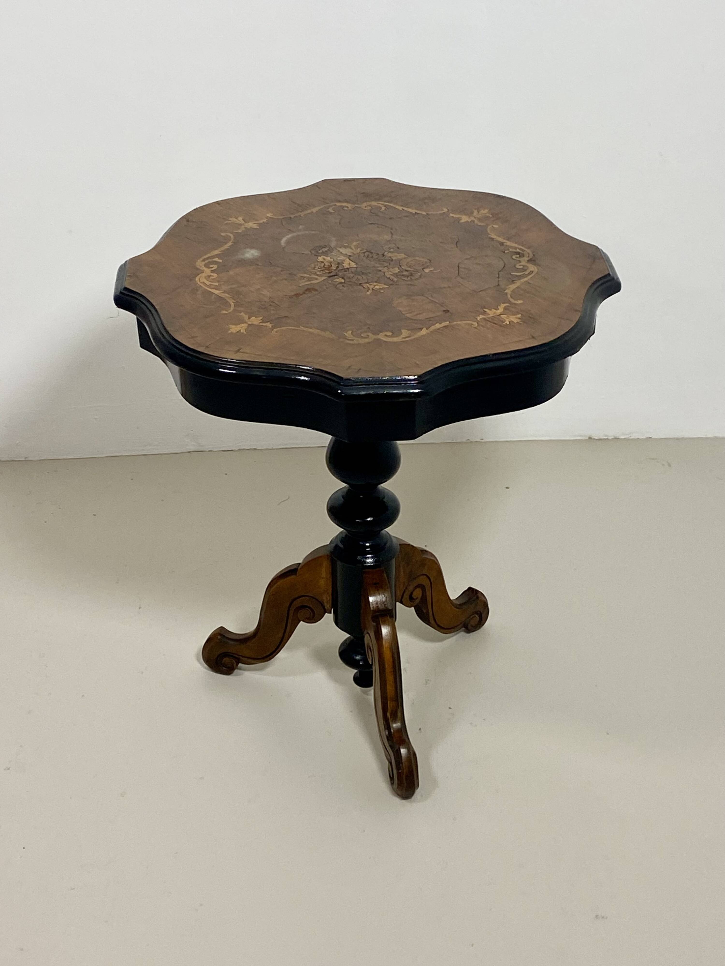 Two-tone black and mahogany pedestal table with mahogany veneer