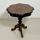 Two-tone black and mahogany pedestal table with mahogany veneer