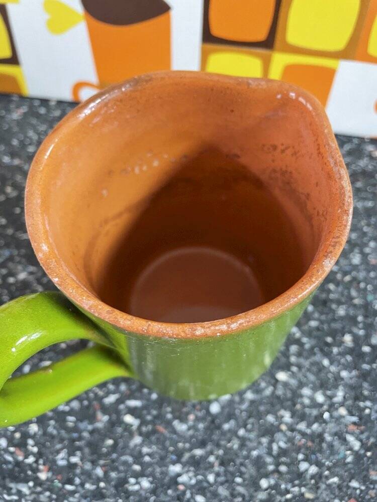 Small two-tone green glazed terracotta jug, height 12 cm.