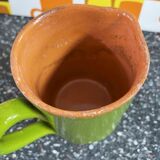 Small two-tone green glazed terracotta jug, height 12 cm.