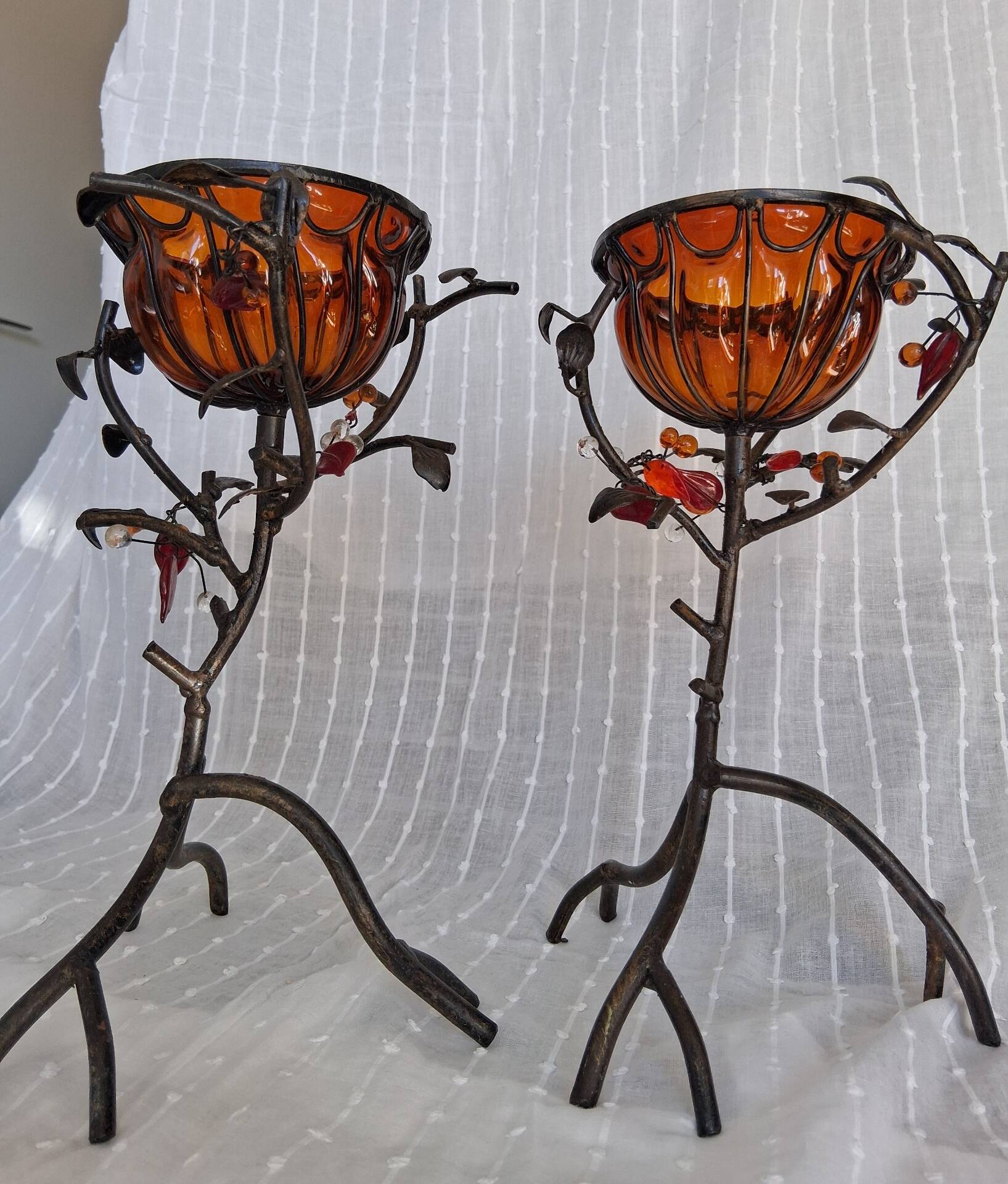 Pair of Art Deco style candle holders in wrought iron and amber blown glass.