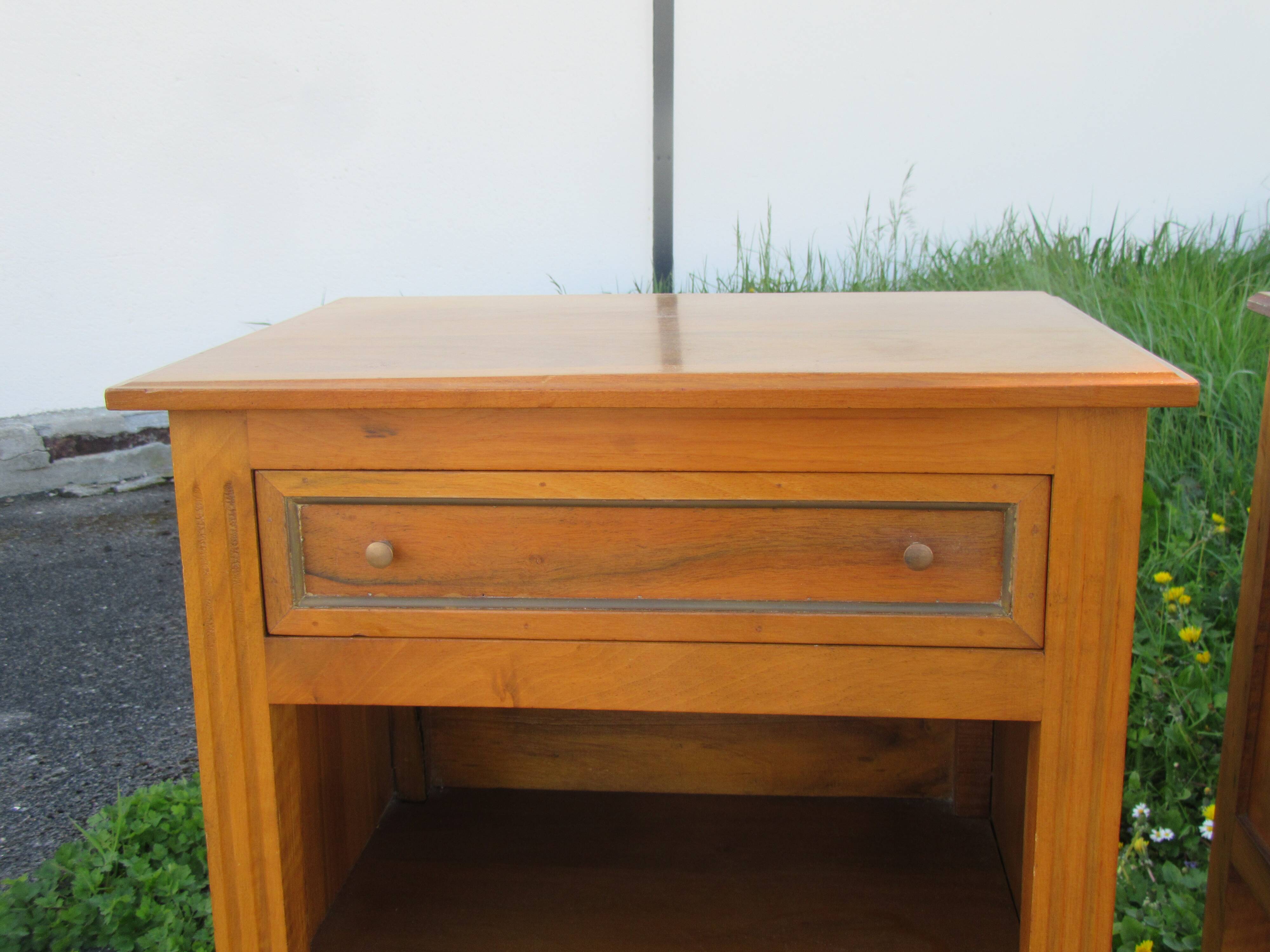 Pair of walnut bedside tables in Louis XVI style with brass inlay.