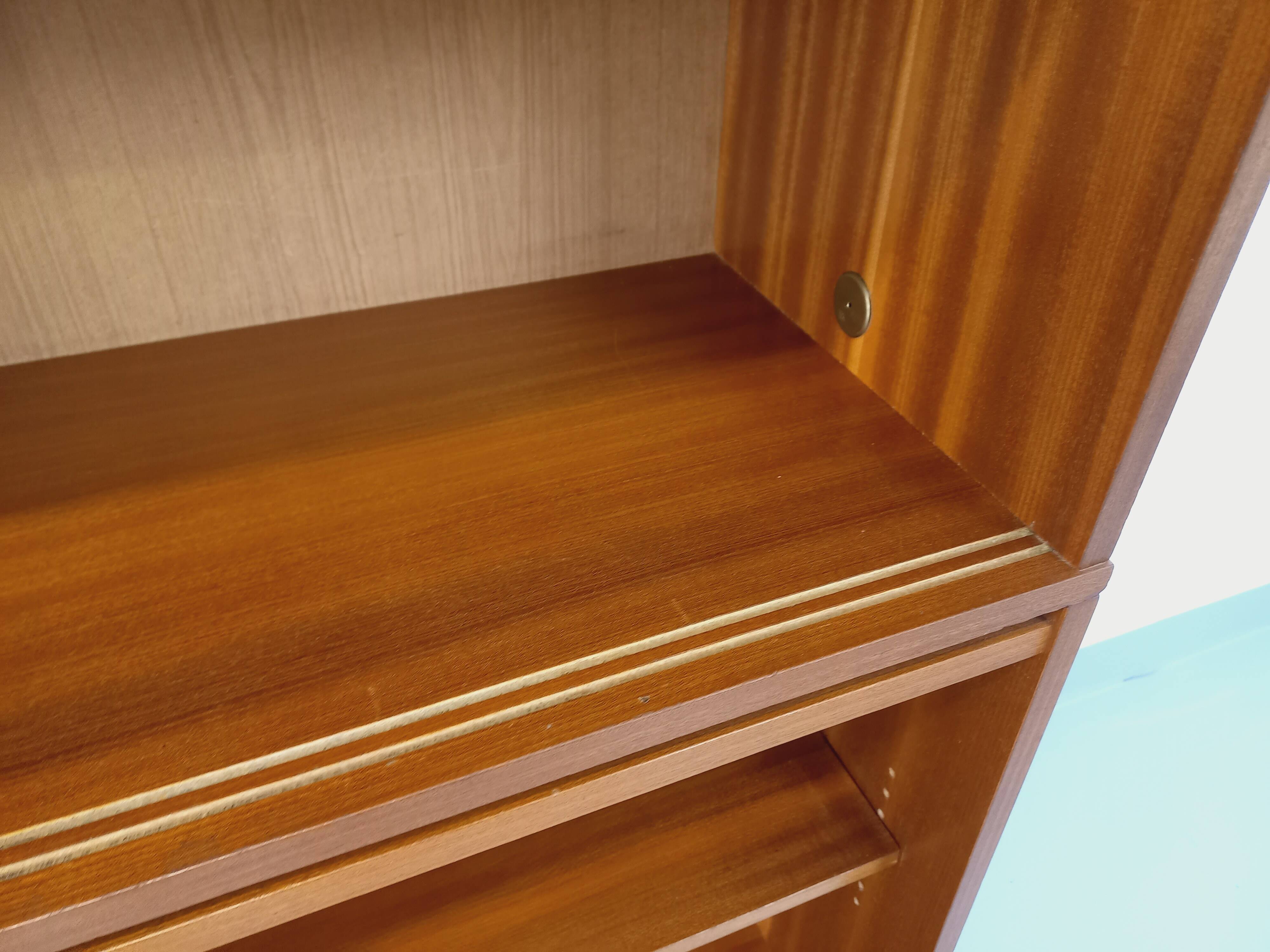 Vintage wooden bookshelf in teak style from the 1960s.