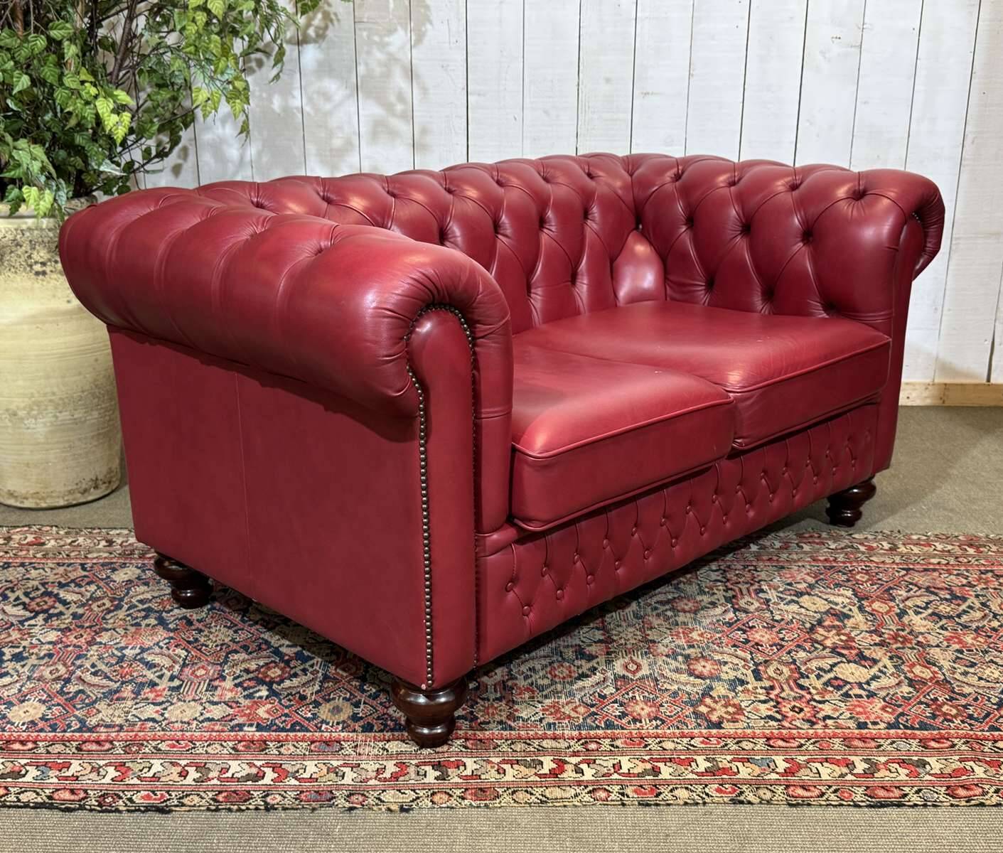 Chesterfield 2-seater leather sofa, modern production from the 2000s.