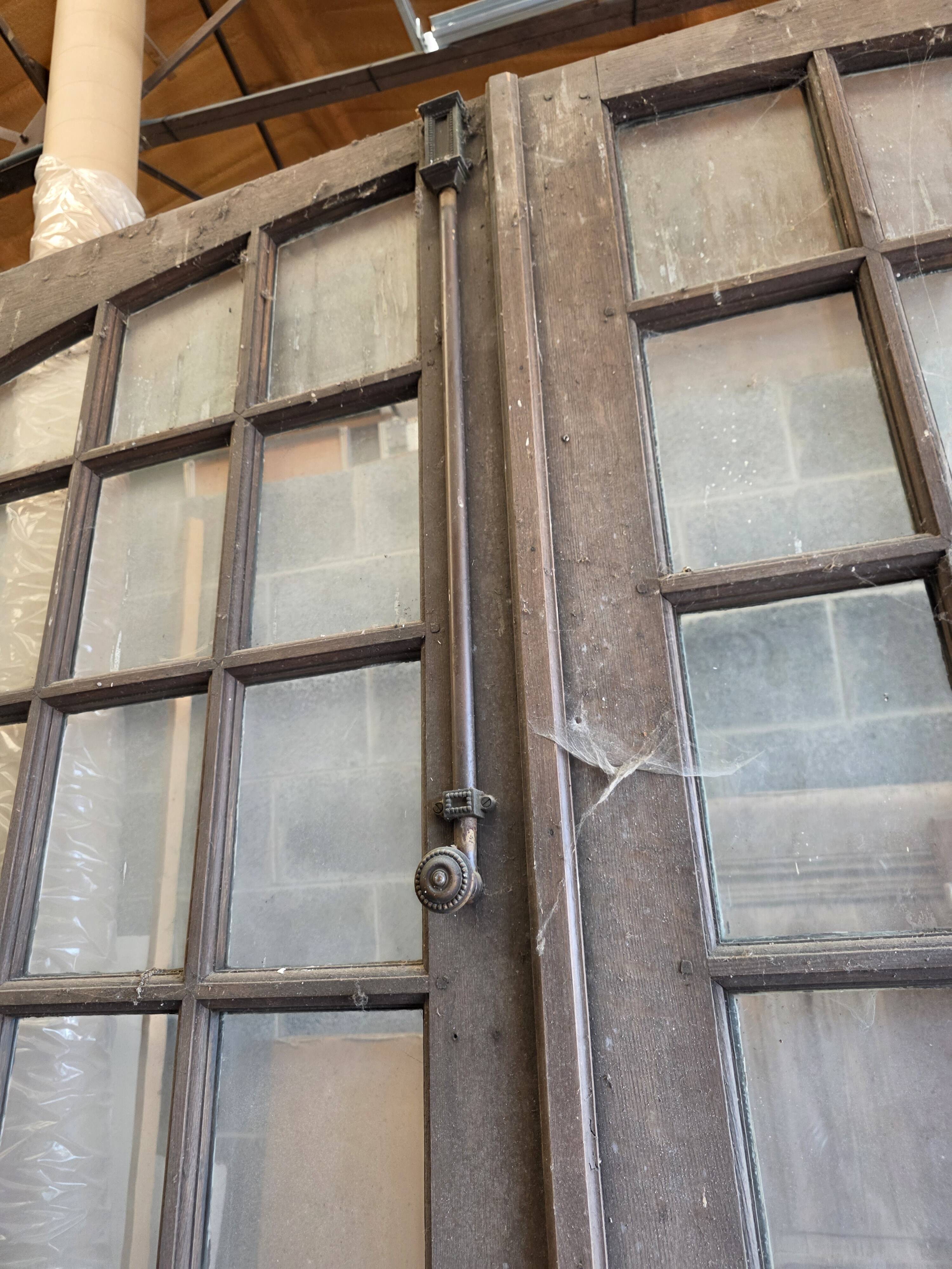 Two pairs of solid oak doors with small panes.