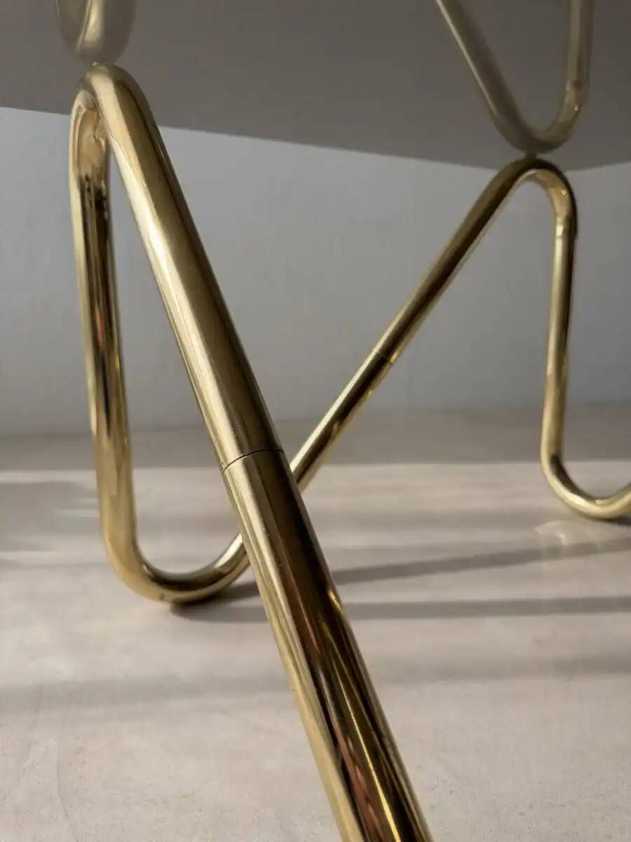 Coffee table with smoked glass and curved metal base