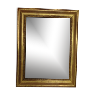 Miroir Empire début XIXème, doré à la feuille h 56 cm