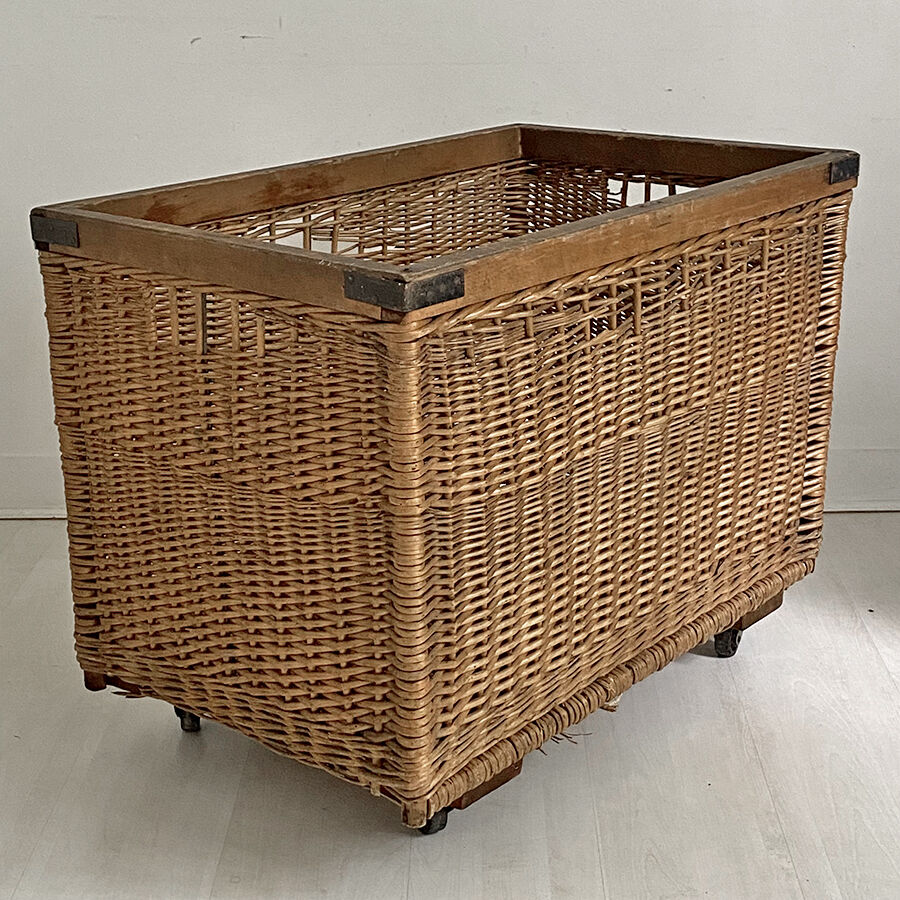 Old large wicker laundry basket on wheels