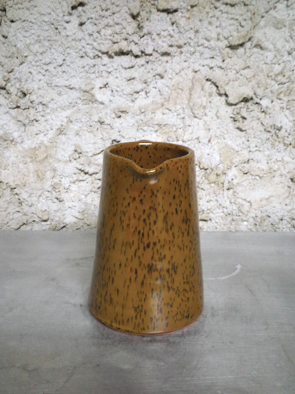 Milk pitcher in spotted sandstone