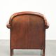 Comfortable vintage sheepskin armchair finished with decorative nails
