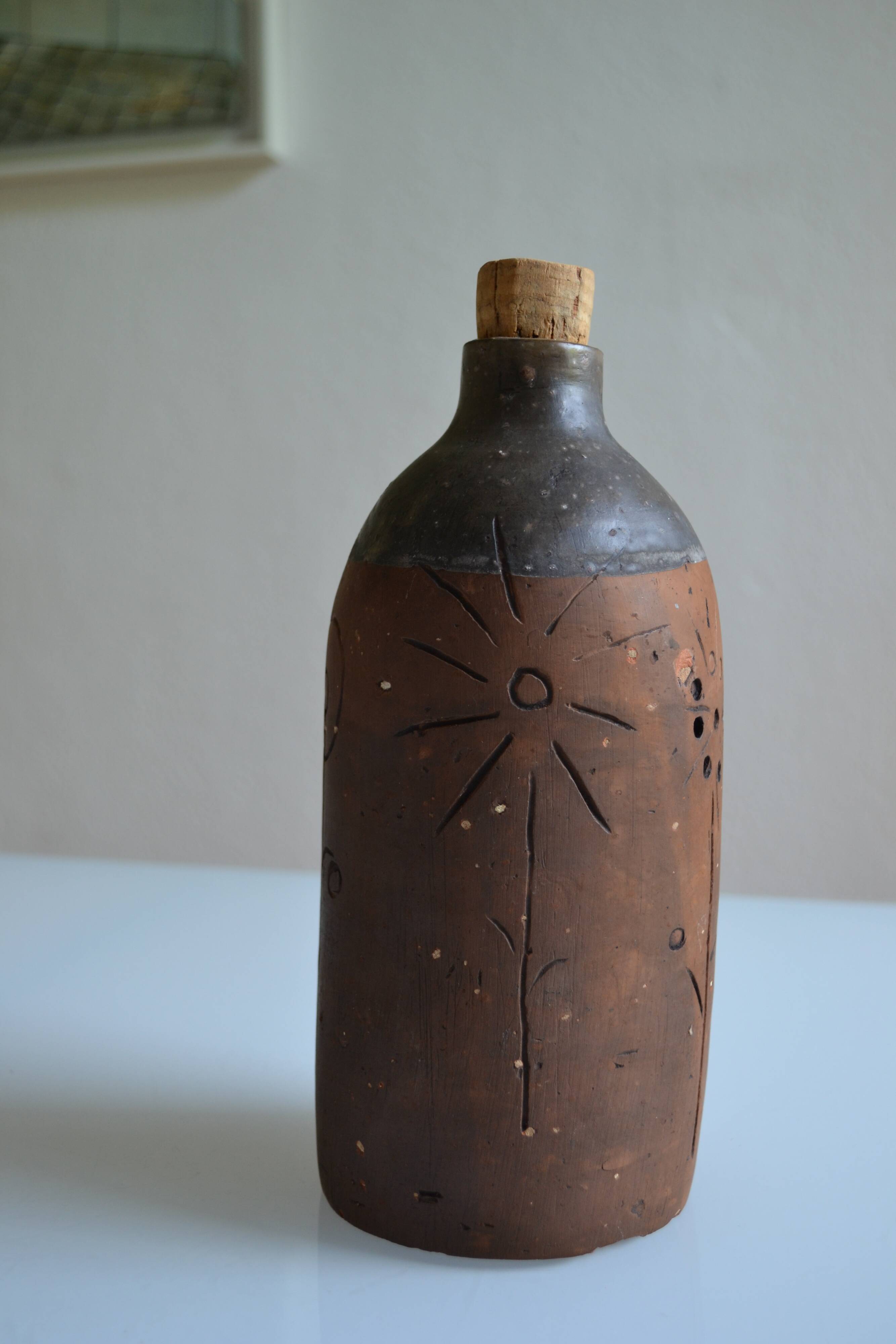 Bottle vase decorative flowers ceramic signature with fish to identify.