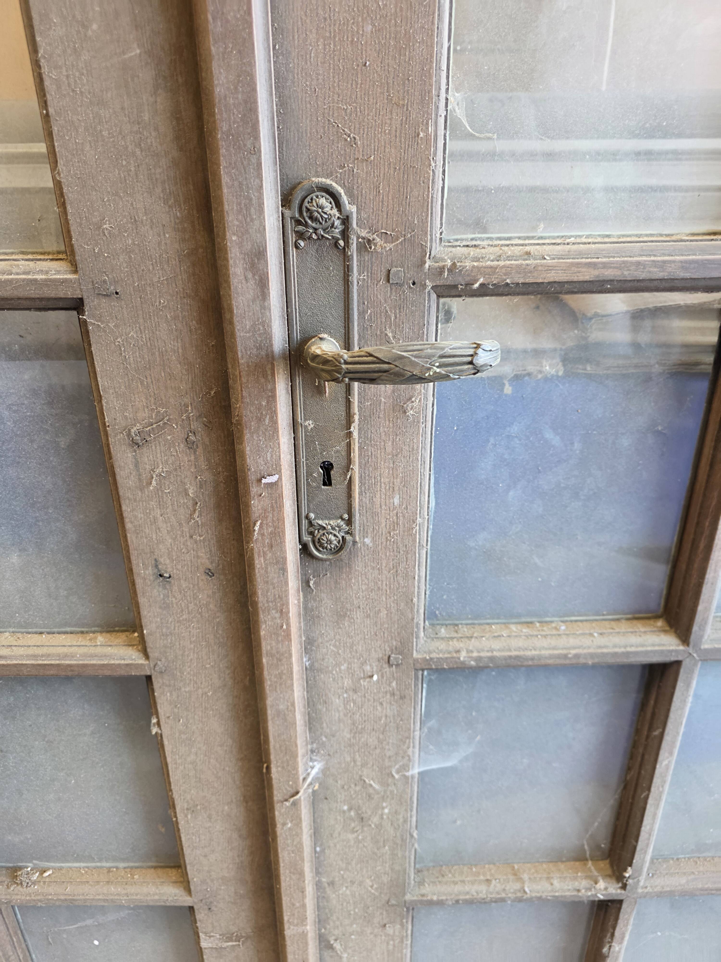 Two pairs of solid oak doors with small panes.