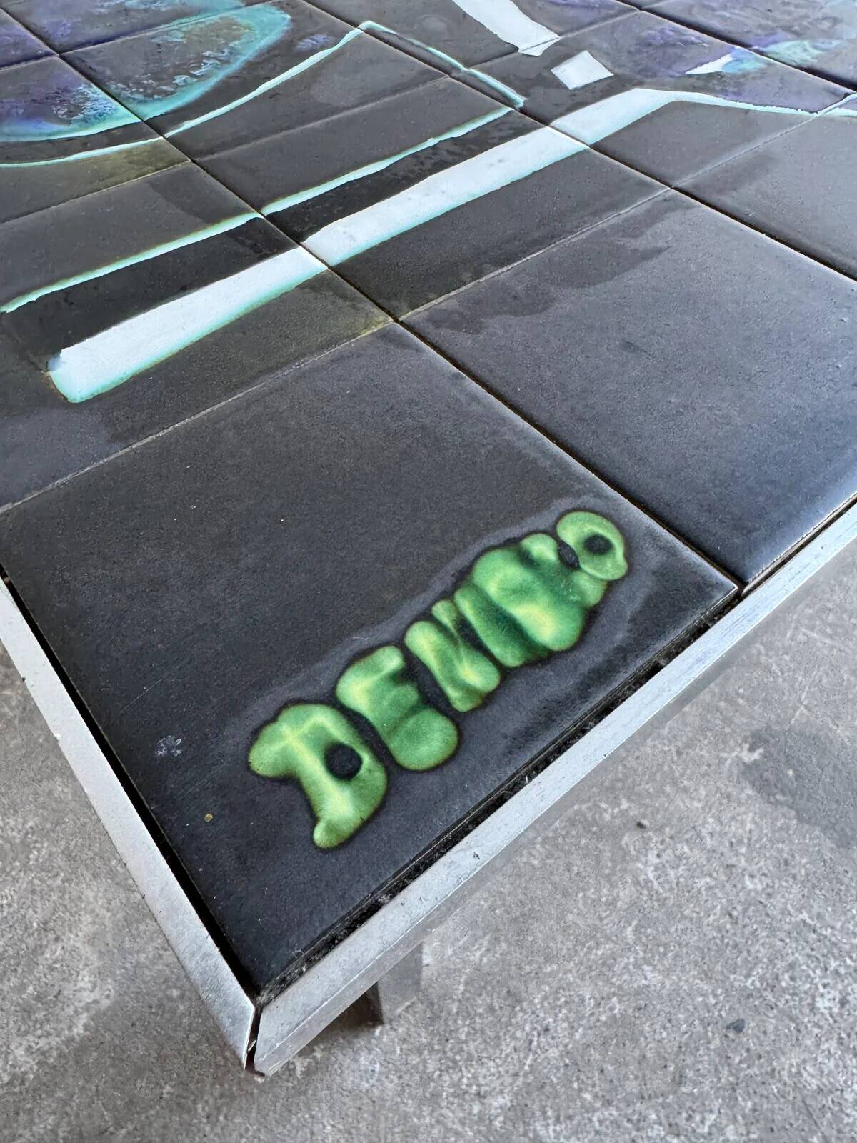 Mid-century Denisco ceramic coffee table — black, blue and white glazed tile top with silver metal base
