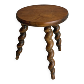 Small antique tripod stool in dark wood.