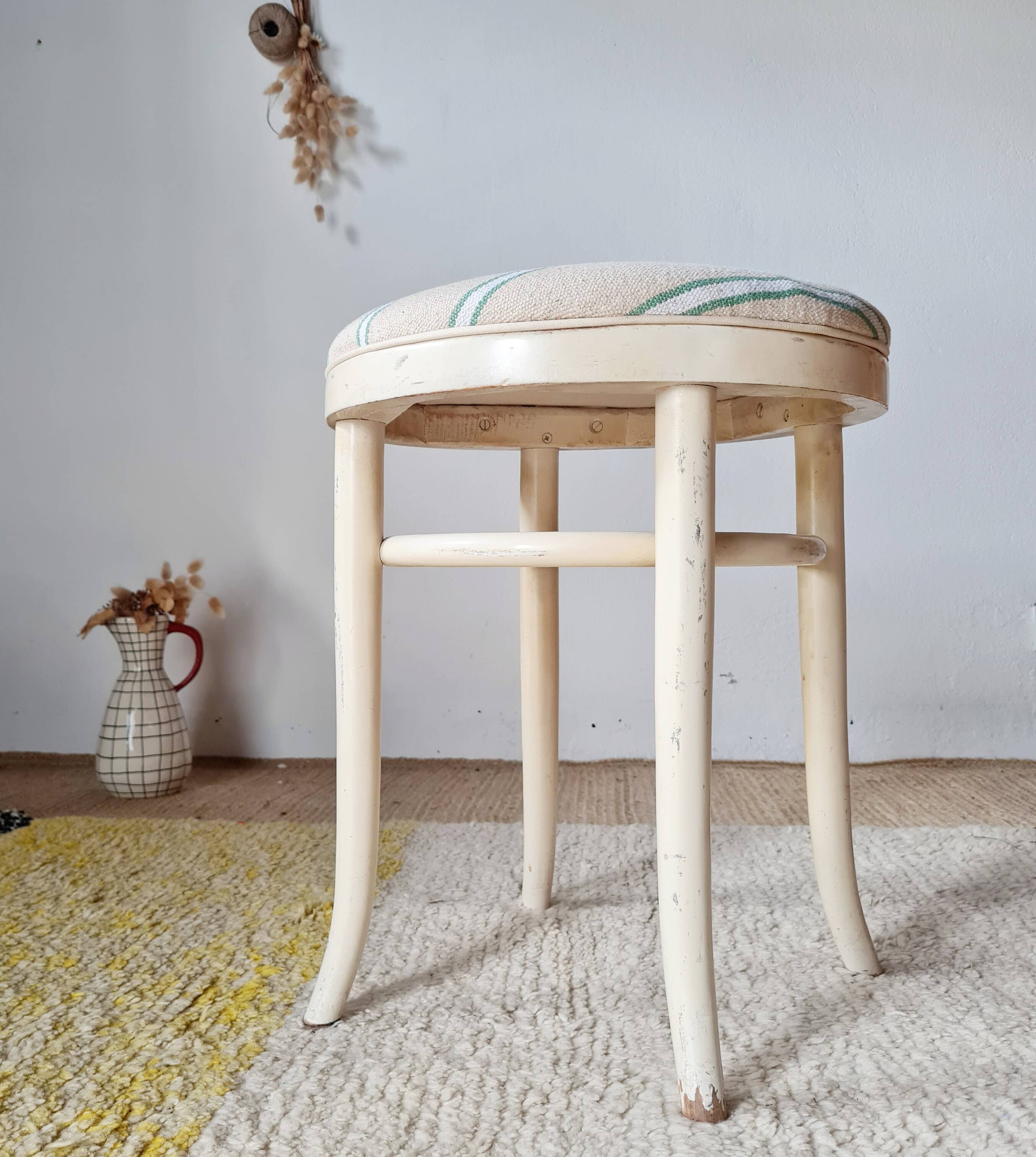 Vintage curved wooden stool in Baumann style, striped fabric seat.