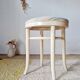 Vintage curved wooden stool in Baumann style, striped fabric seat.