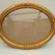 Large old oval gilded wooden frame and stucco decorations