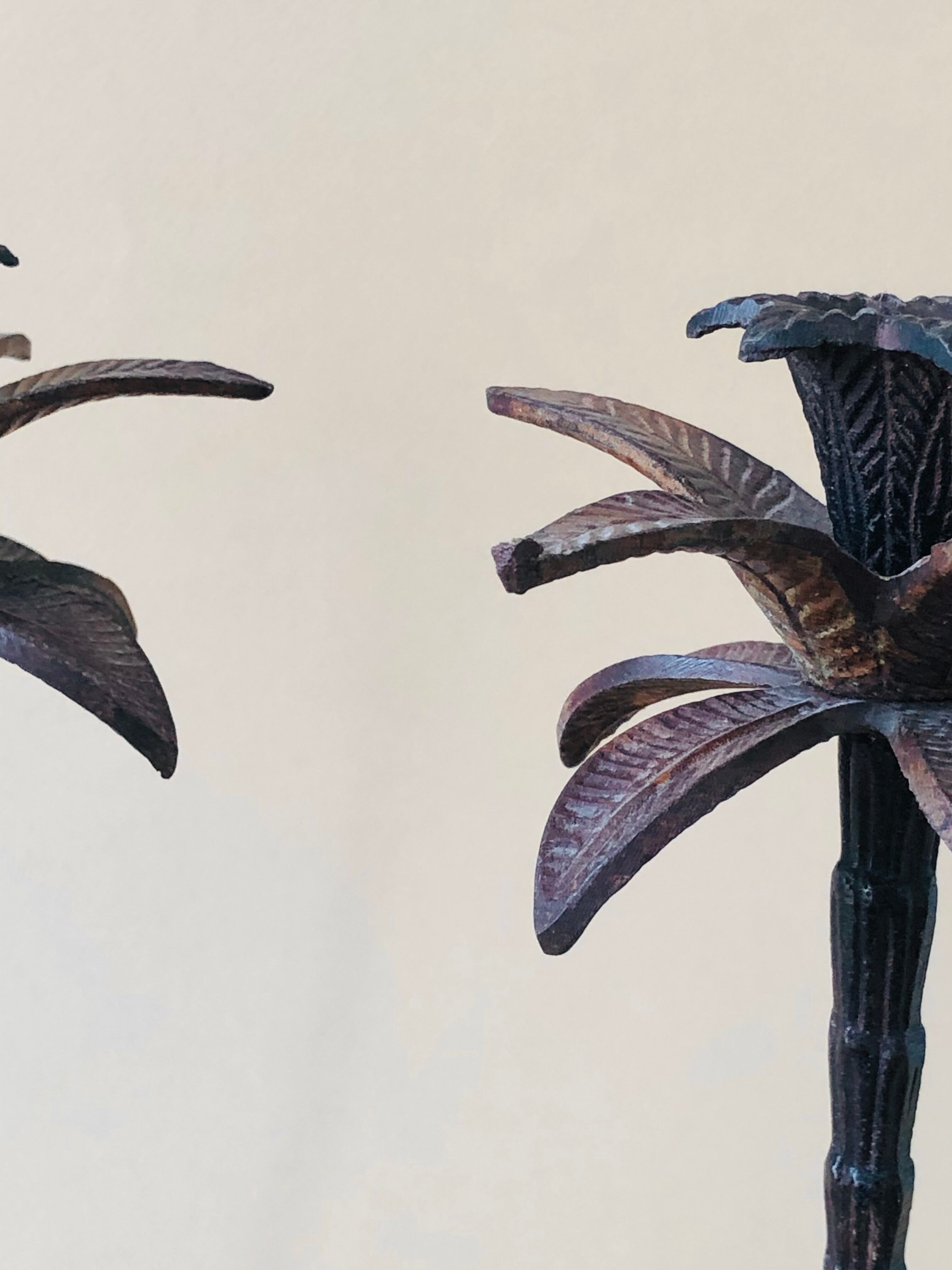 Pair of patinated metal candlesticks