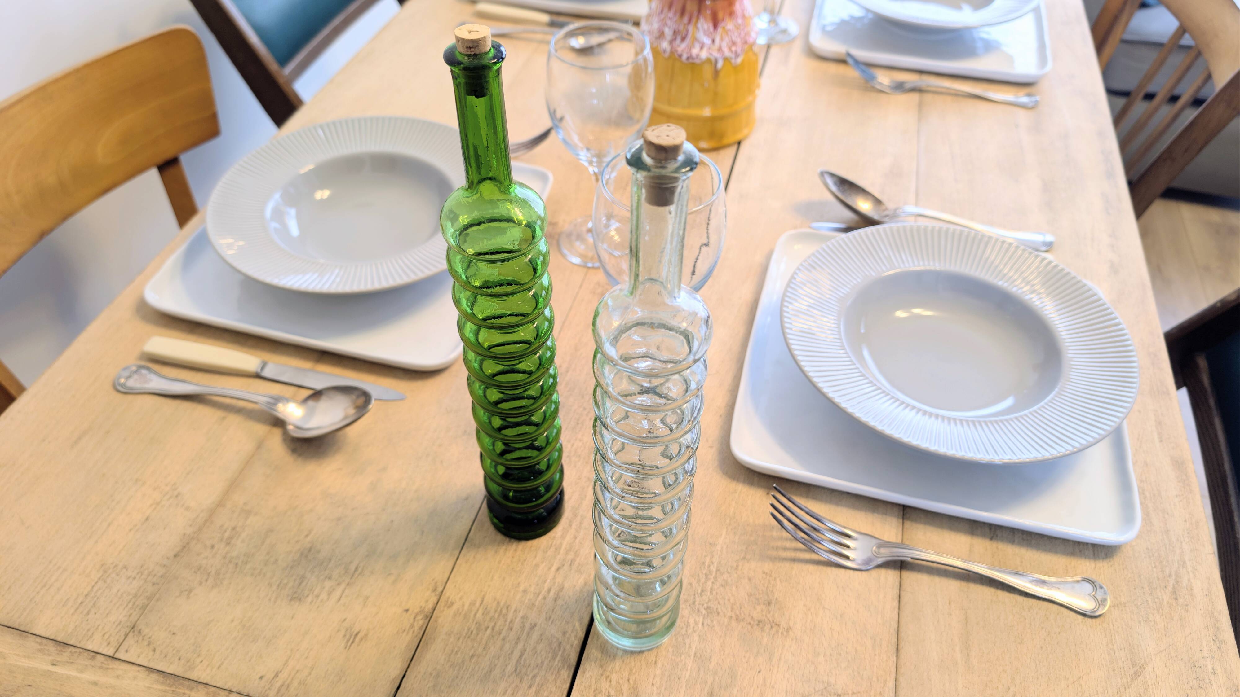 Pair of vintage ribbed blown glass bottles with cork stoppers.