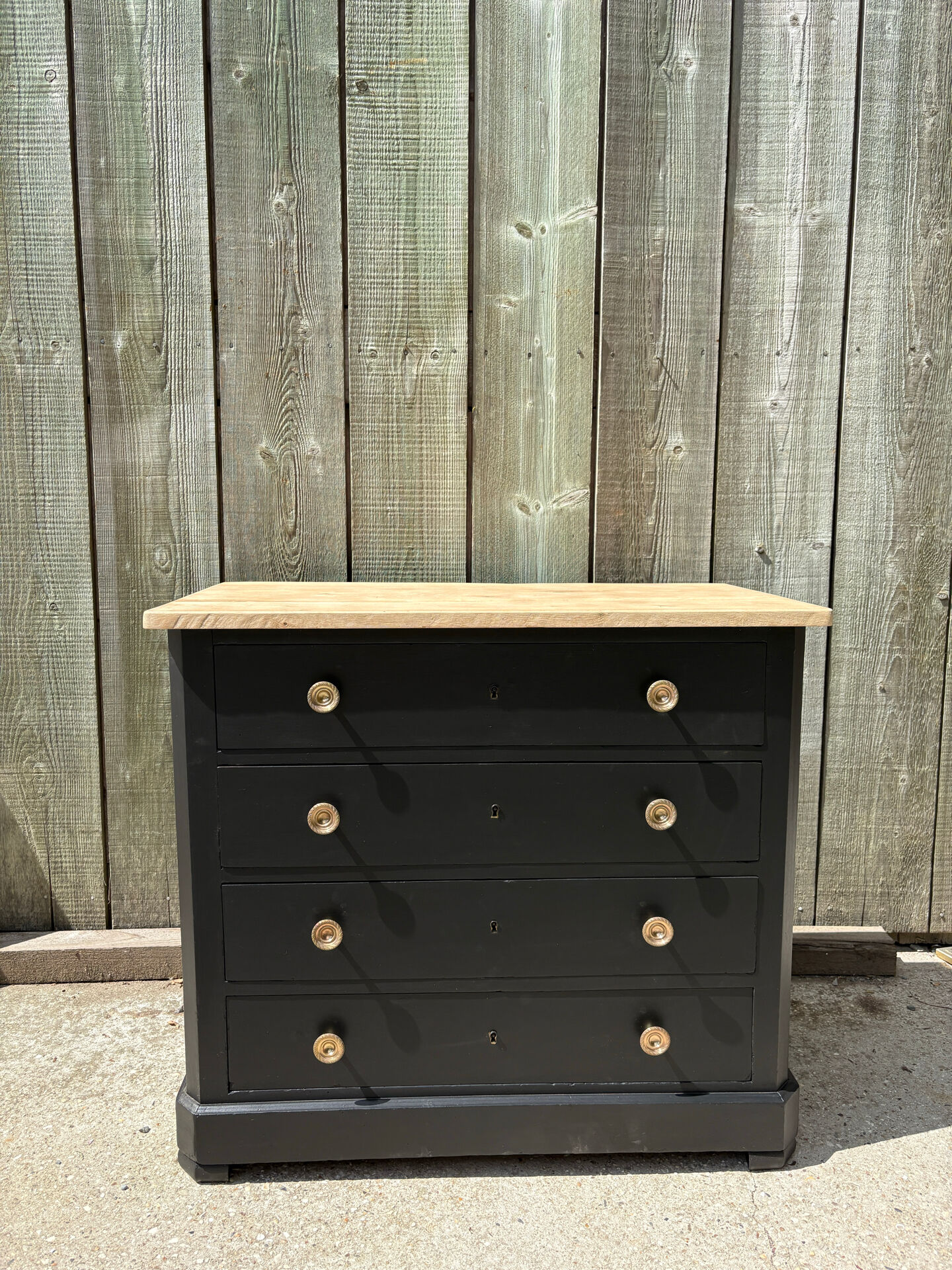 Antique commode with a matte black finish.
