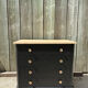 Antique commode with a matte black finish.