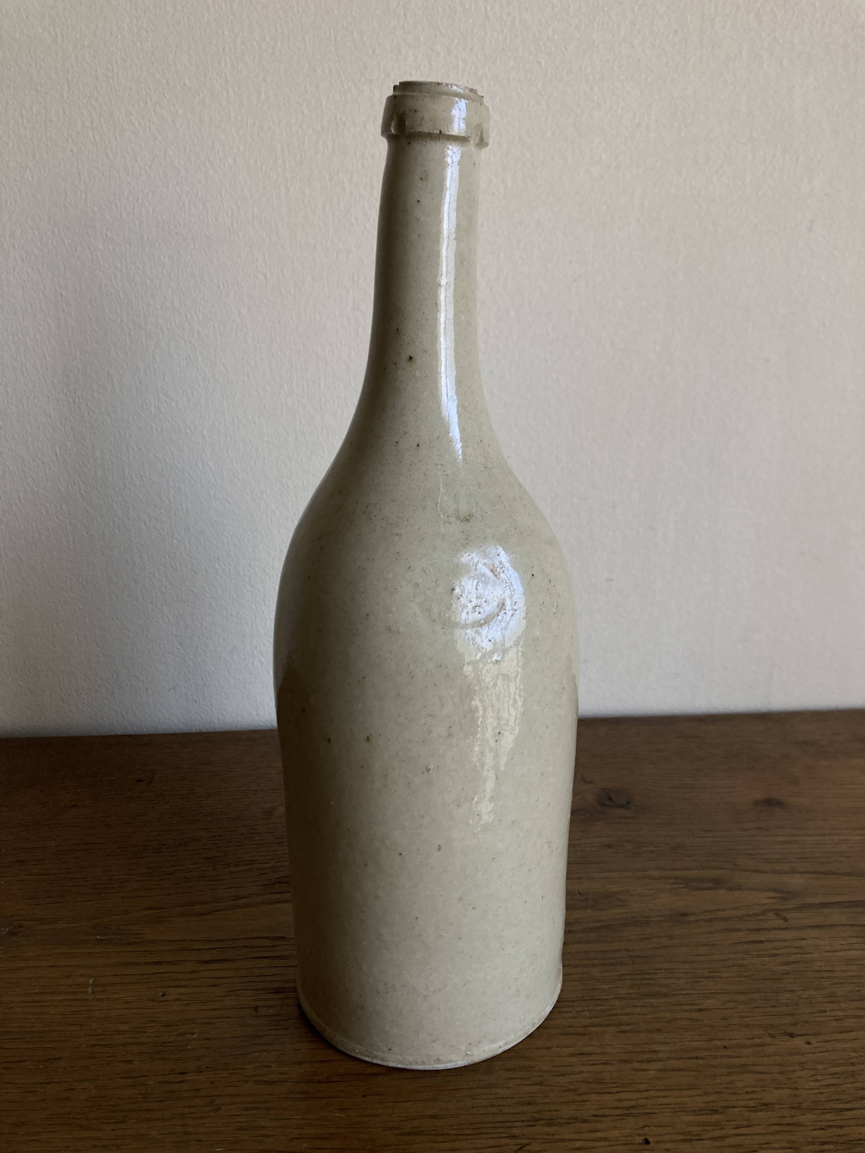 Stoneware bottle tilted at an angle, early 20th century