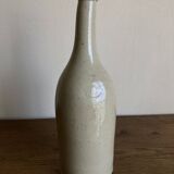 Stoneware bottle tilted at an angle, early 20th century