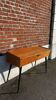 Vintage wooden console/desk with tapered legs.