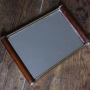 Rectangular mirror tray with wooden handles and gilding.