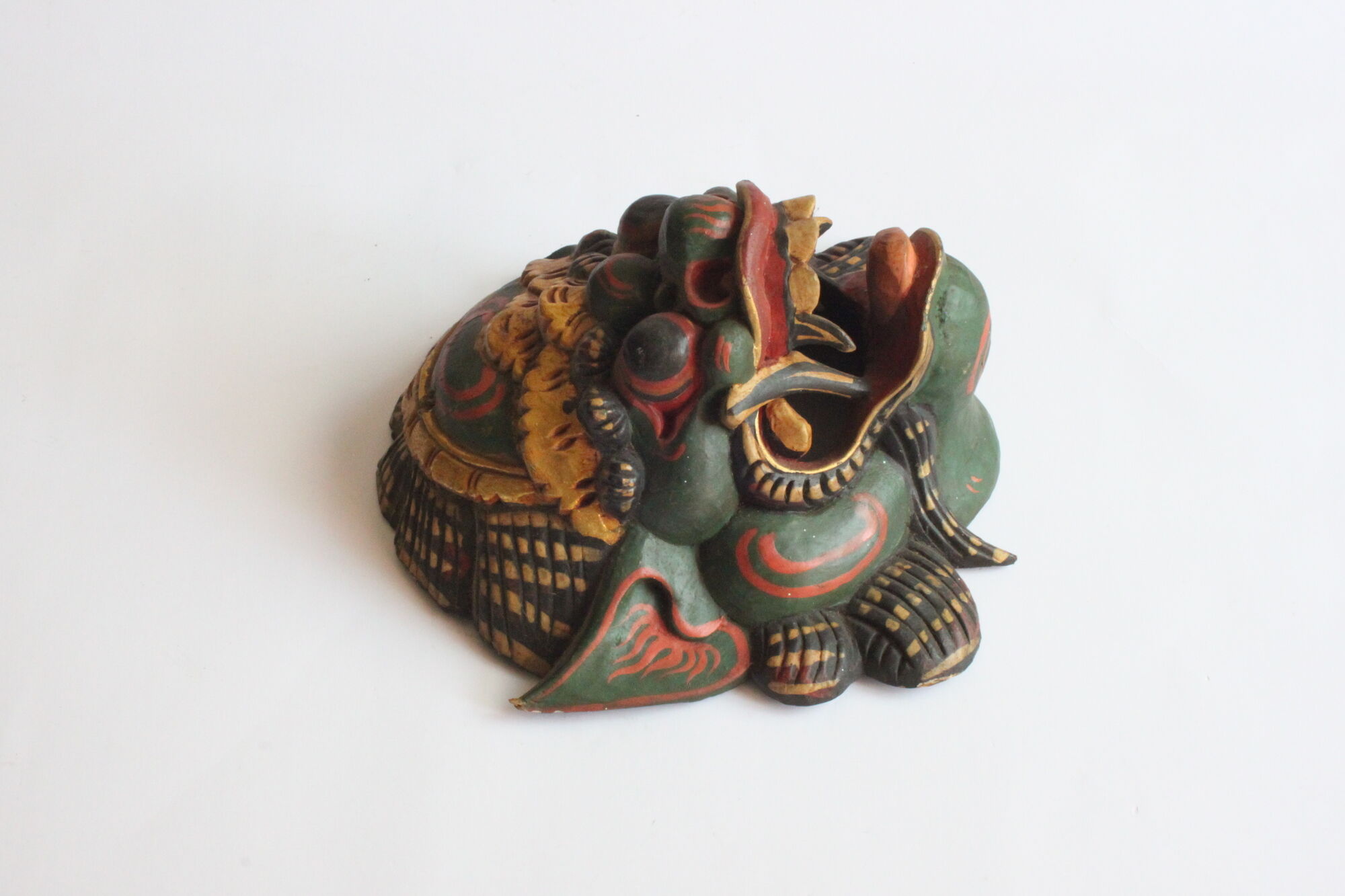 Two polychrome painted and gold leaf gilded Barong dance masks from Bali, Indonesia.