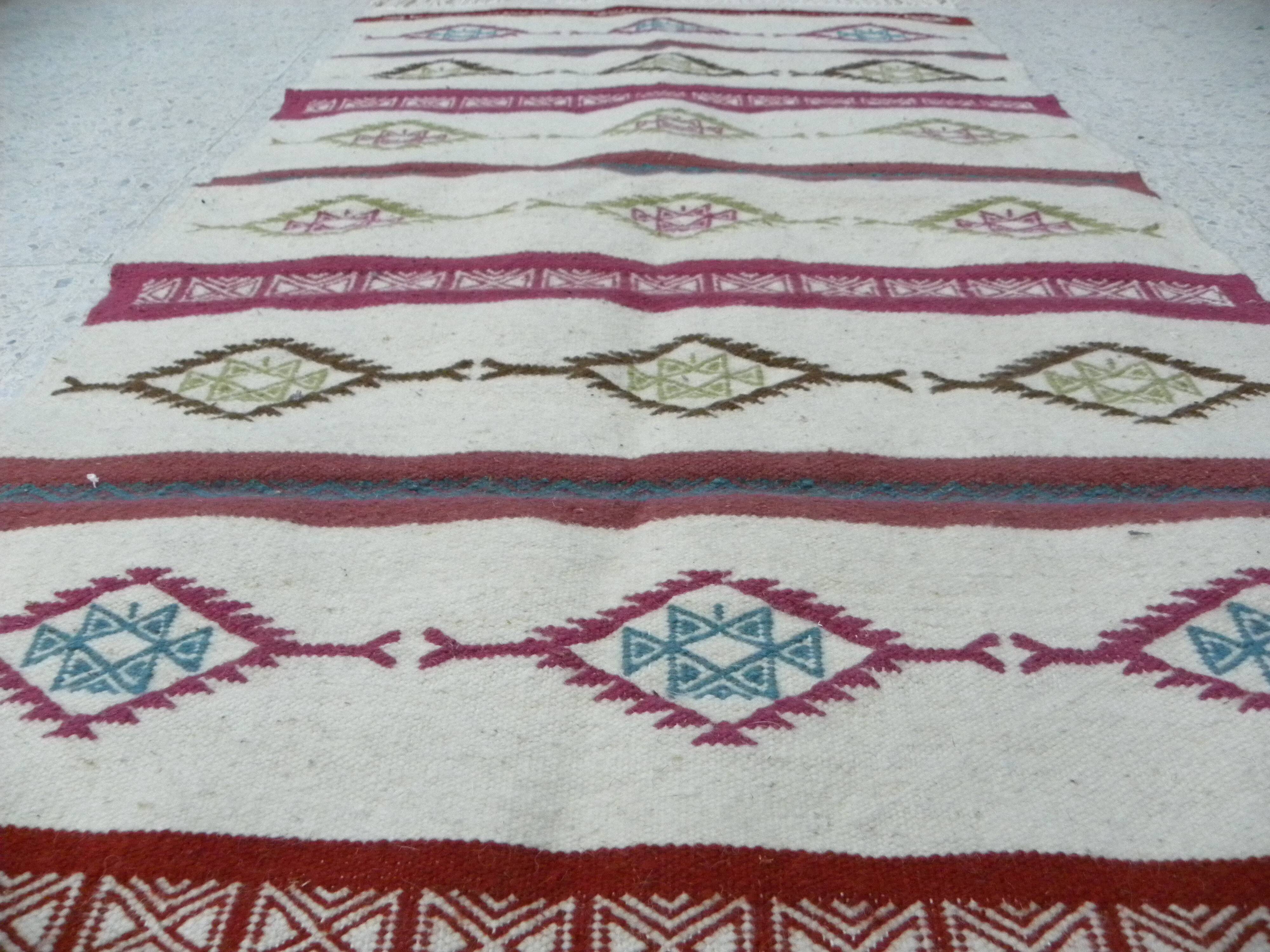 Tribal bohemian kilim rug with geometric pattern in wool.