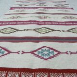 Tribal bohemian kilim rug with geometric pattern in wool.