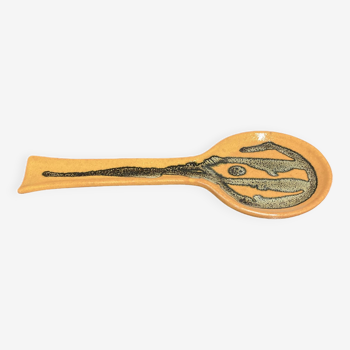 Orange ceramic spoon holder.