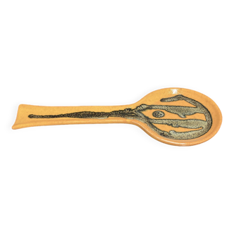 Orange ceramic spoon holder.