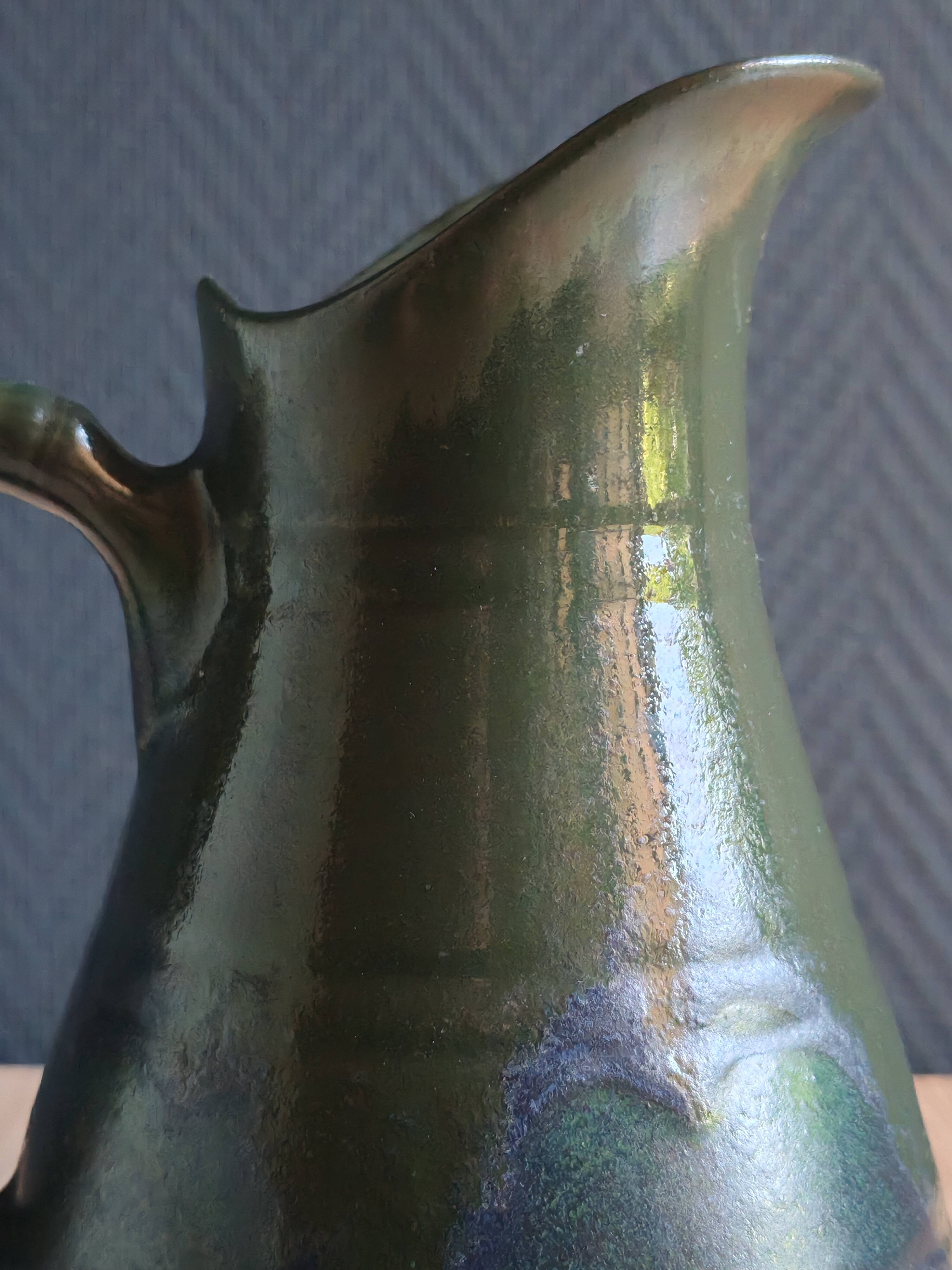 Vintage ceramic pitcher vase in glazed green and blue.