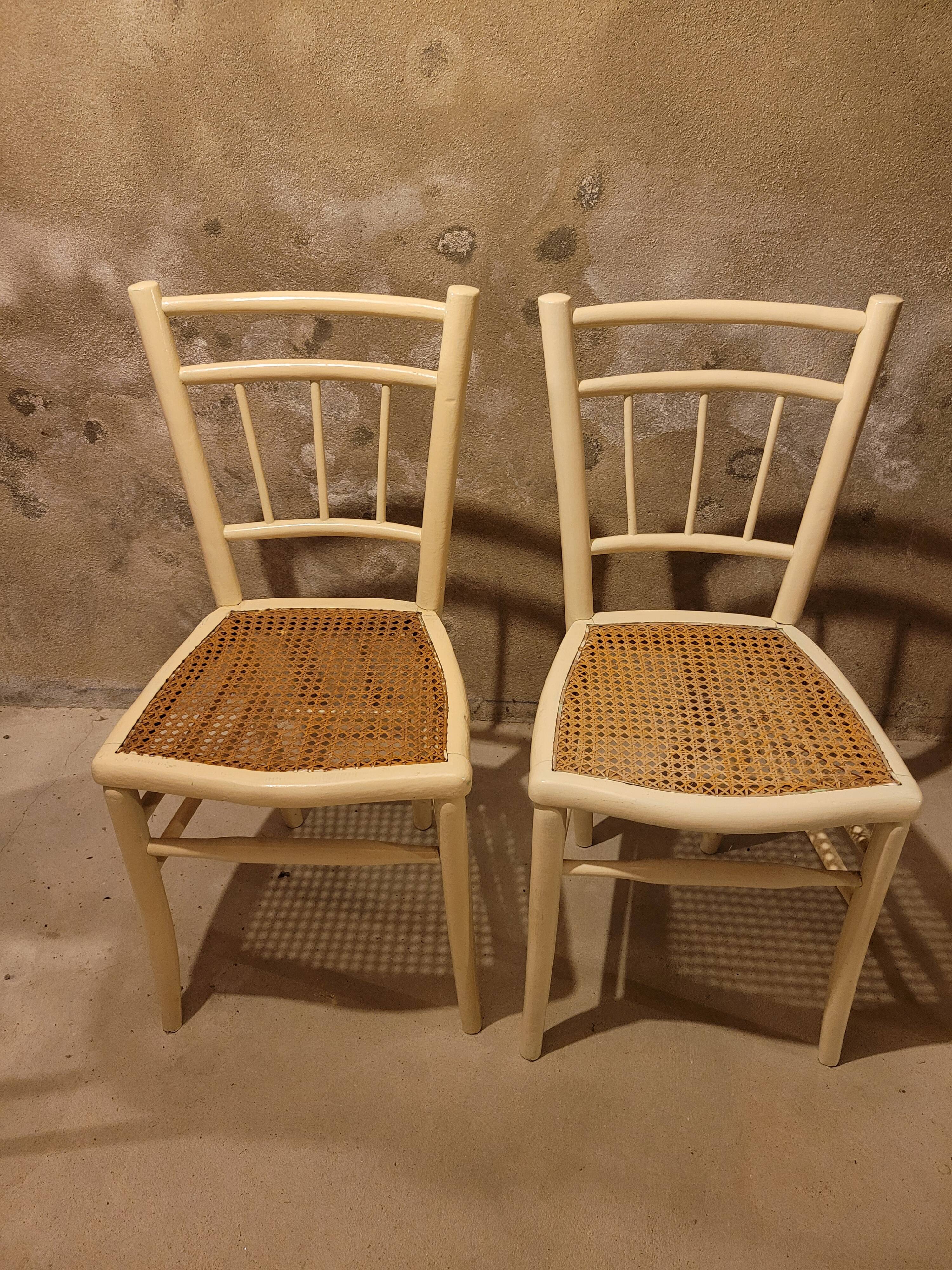 2 white wooden chairs