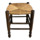 Wooden stool with a straw seat